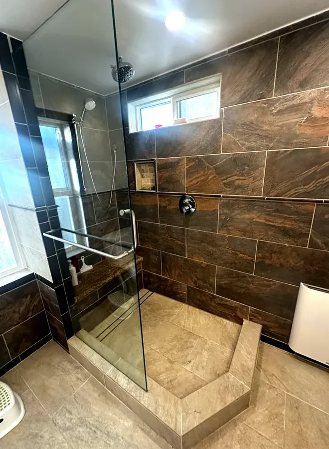 Frameless glass shower panel on a remodeled walk-in shower in the Tri-Cities