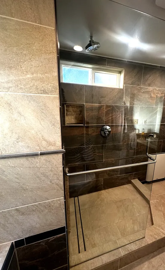 Remodeled walk-in shower with new frameless glass panel in the Tri-Cities